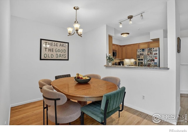 2954 Kalmia Ave # 34, Boulder, CO 80301 - dining room with a chandelier and light wood-type flooring
