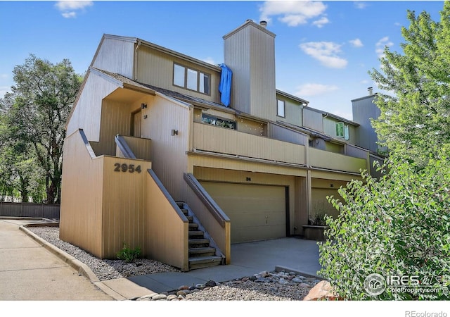 2954 Kalmia Ave # 34, Boulder, CO 80301 - view of front of home with a garage, a chimney, and stairs