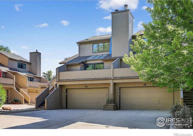 2954 Kalmia Ave # 34, Boulder, CO 80301 - mid-century home with a garage, concrete driveway, a chimney, and stairway