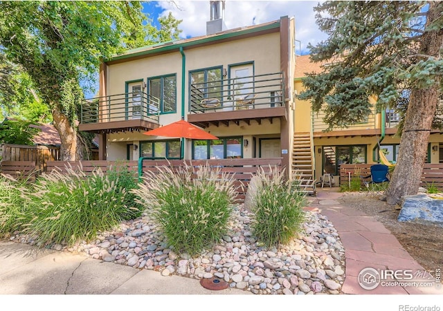 1825 Marine St Unit 8, Boulder, CO 80302 - back of house featuring a balcony, stucco siding, and a chimney