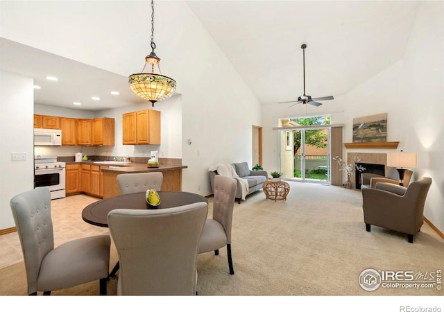 4603 Dusty Sage Ct Unit 4, Fort Collins, CO 80526 - dining area featuring high vaulted ceiling, light colored carpet, ceiling fan, recessed lighting, and a glass covered fireplace