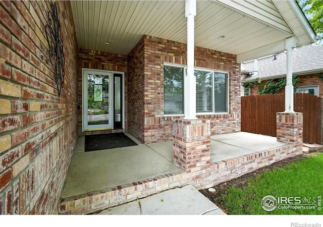 2078 Goldfinch Ct, Longmont, CO 80503 - doorway to property with brick siding and covered porch