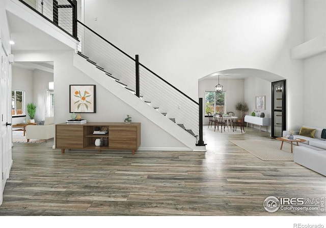2078 Goldfinch Ct, Longmont, CO 80503 - entryway with a high ceiling, arched walkways, wood finished floors, and stairway