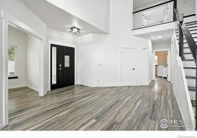 2078 Goldfinch Ct, Longmont, CO 80503 - foyer with wood finished floors, stairway, and a towering ceiling
