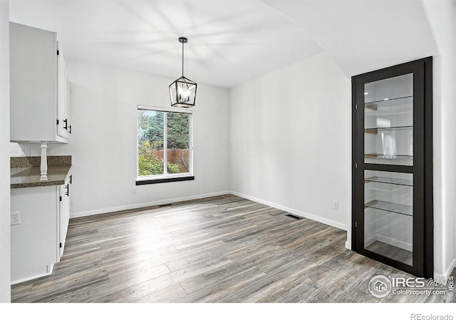 2078 Goldfinch Ct, Longmont, CO 80503 - unfurnished dining area with wood finished floors and a chandelier