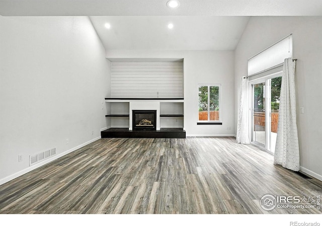 2078 Goldfinch Ct, Longmont, CO 80503 - unfurnished living room featuring wood finished floors, a glass covered fireplace, and recessed lighting