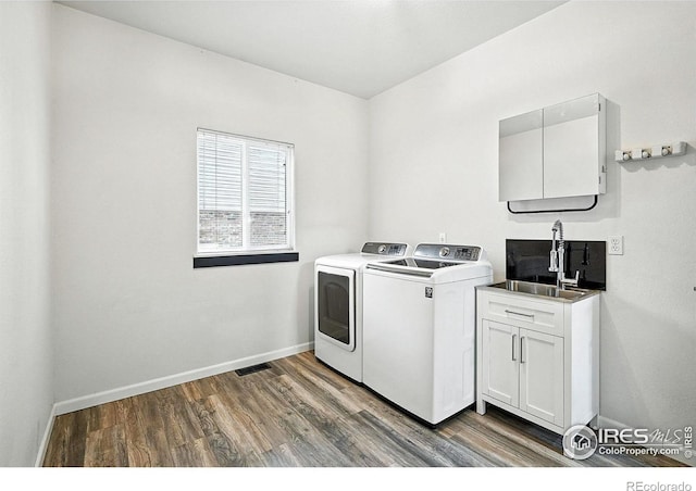2078 Goldfinch Ct, Longmont, CO 80503 - laundry room with separate washer and dryer, cabinet space, and wood finished floors