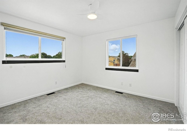 2078 Goldfinch Ct, Longmont, CO 80503 - unfurnished bedroom with multiple windows, carpet floors, a closet, and ceiling fan
