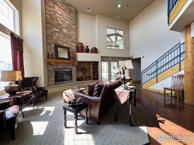 4101 Crittenton Ln Unit 102, Wellington, CO 80549 - living room featuring a towering ceiling, hardwood / wood-style floors, a fireplace, and stairway