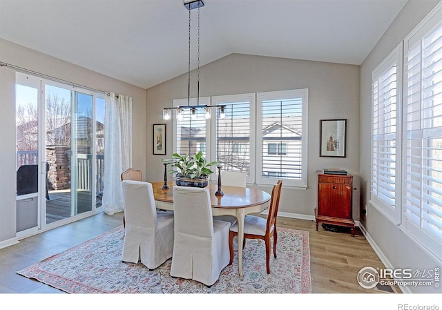16021 Williams Pl, Broomfield, CO 80023 - dining space featuring light wood-style floors, vaulted ceiling, and a chandelier