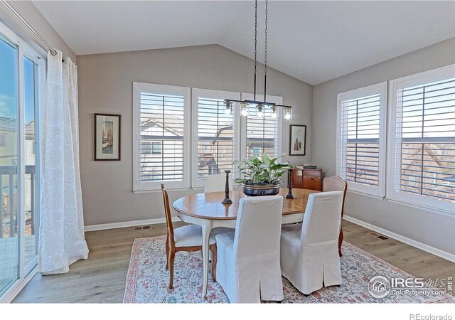 16021 Williams Pl, Broomfield, CO 80023 - dining space with light wood-style floors, vaulted ceiling, and a chandelier