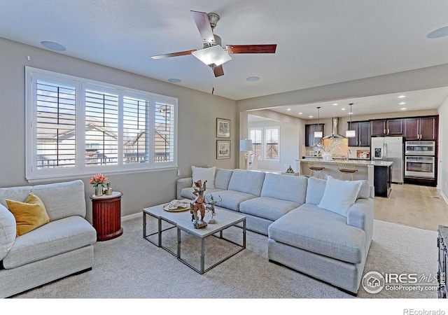 16021 Williams Pl, Broomfield, CO 80023 - living room with light colored carpet, a ceiling fan, and recessed lighting