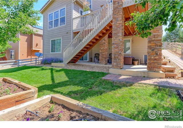 16021 Williams Pl, Broomfield, CO 80023 - back of house with stairs, a patio, a vegetable garden, and a wooden deck