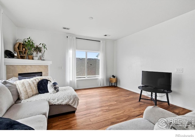 14700 E 104th Ave Unit 2605, Commerce City, CO 80022 - living area with wood finished floors and a tile fireplace