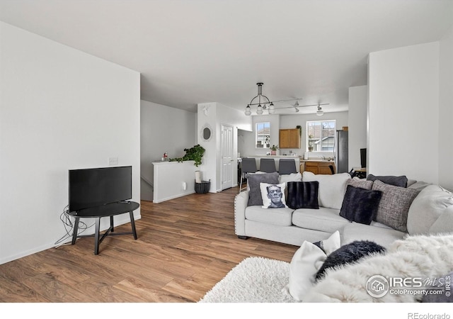 14700 E 104th Ave Unit 2605, Commerce City, CO 80022 - living area with a chandelier and light wood-style floors