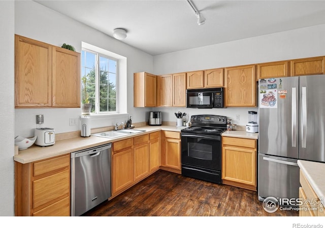 14700 E 104th Ave Unit 2605, Commerce City, CO 80022 - kitchen with black appliances, light countertops, dark wood-style floors, track lighting, and light brown cabinets