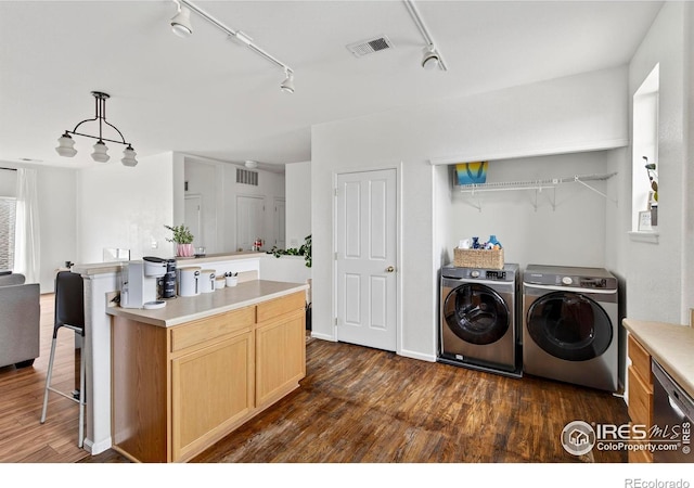 14700 E 104th Ave Unit 2605, Commerce City, CO 80022 - laundry room with independent washer and dryer, dark wood-style flooring, and track lighting