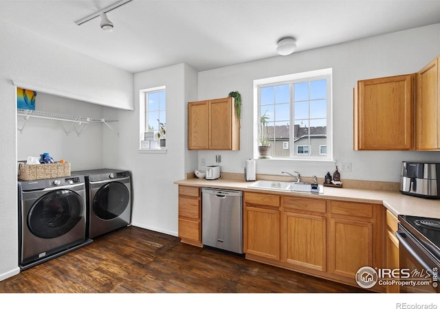 14700 E 104th Ave Unit 2605, Commerce City, CO 80022 - kitchen with stainless steel dishwasher, independent washer and dryer, plenty of natural light, and dark wood-style flooring
