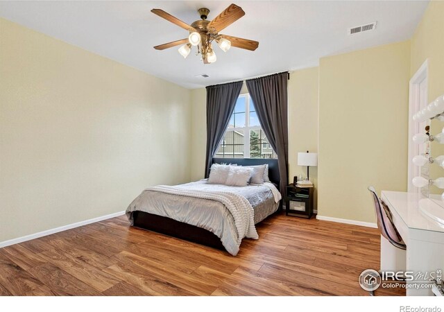 14700 E 104th Ave Unit 2605, Commerce City, CO 80022 - bedroom with light wood-style floors and ceiling fan