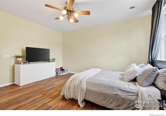 14700 E 104th Ave Unit 2605, Commerce City, CO 80022 - bedroom with wood finished floors and a ceiling fan