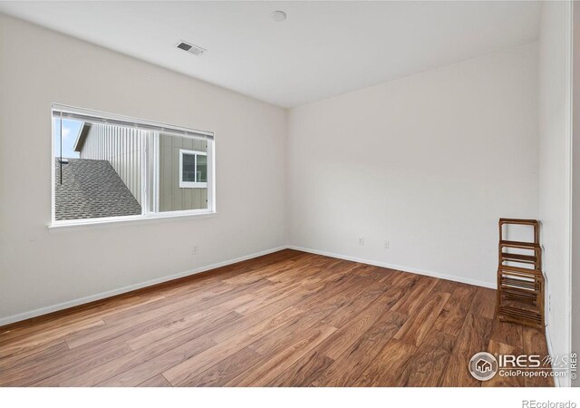 14700 E 104th Ave Unit 2605, Commerce City, CO 80022 - empty room with wood finished floors and baseboards