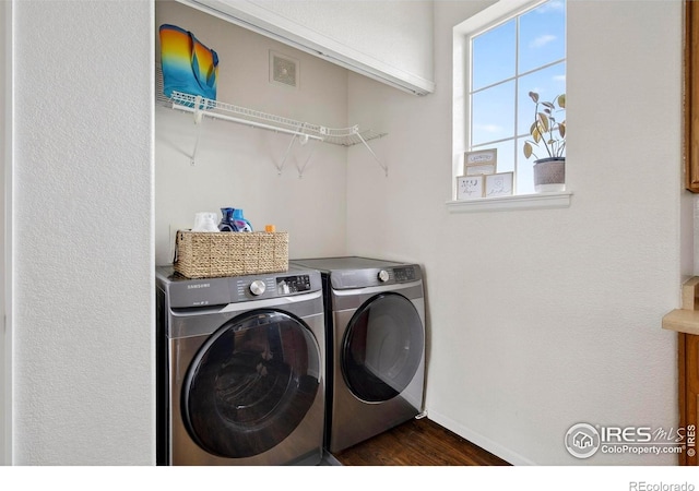 14700 E 104th Ave Unit 2605, Commerce City, CO 80022 - laundry area featuring washer and clothes dryer and dark wood-style flooring