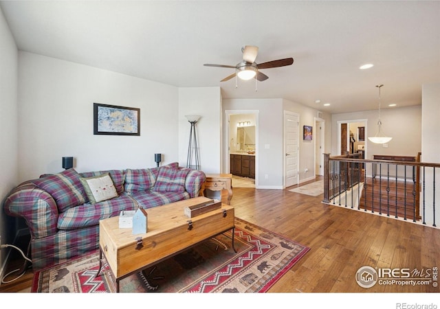 1325 Tipton St, Berthoud, CO 80513 - living room featuring hardwood / wood-style floors, a ceiling fan, and recessed lighting