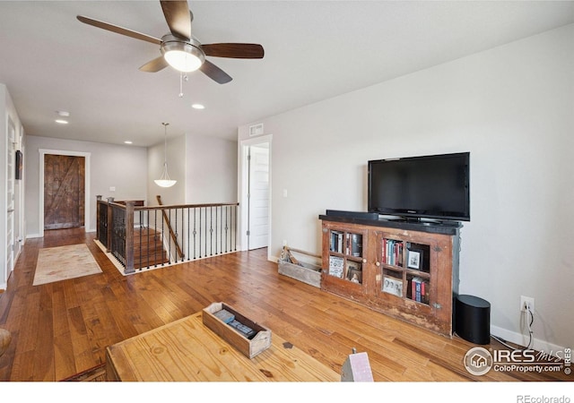 1325 Tipton St, Berthoud, CO 80513 - living area featuring wood finished floors, a ceiling fan, and recessed lighting