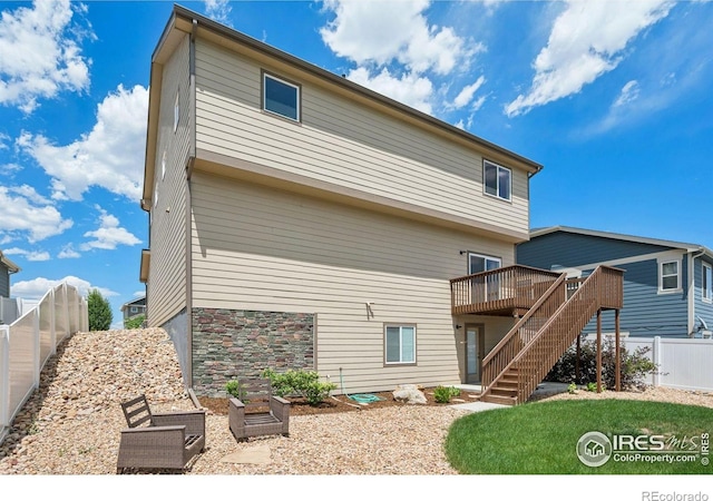 1325 Tipton St, Berthoud, CO 80513 - rear view of property with a wooden deck, stairway, and stone siding