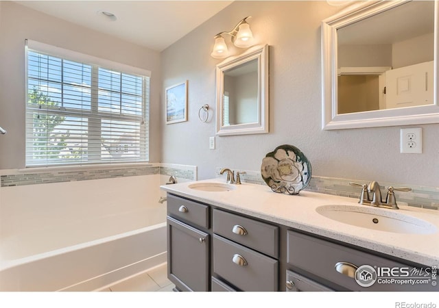 549 Jackson St, Lafayette, CO 80026 - bathroom with healthy amount of natural light, double vanity, a garden tub, and tile patterned floors