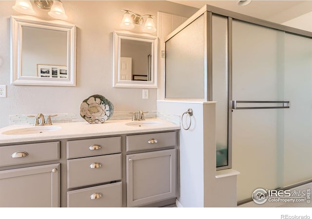 549 Jackson St, Lafayette, CO 80026 - bathroom featuring double vanity and a shower with shower door