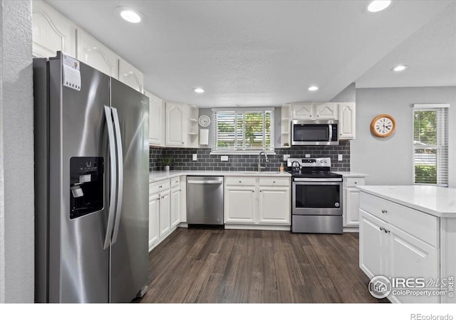 42 Scott Dr S, Broomfield, CO 80020 - kitchen featuring stainless steel appliances, dark wood-type flooring, open shelves, tasteful backsplash, and recessed lighting