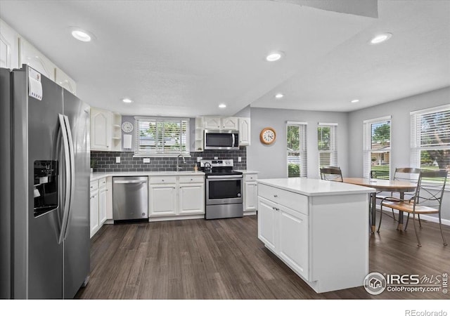 42 Scott Dr S, Broomfield, CO 80020 - kitchen featuring stainless steel appliances, dark wood finished floors, plenty of natural light, light countertops, and recessed lighting