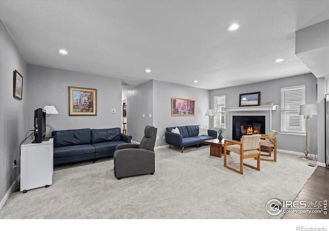 42 Scott Dr S, Broomfield, CO 80020 - living room featuring recessed lighting, a glass covered fireplace, and wood finished floors