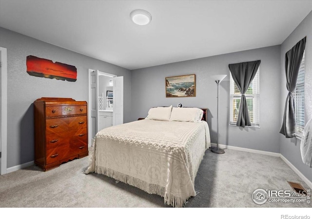 42 Scott Dr S, Broomfield, CO 80020 - carpeted bedroom with baseboards and connected bathroom