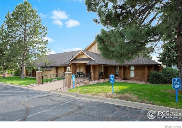 42 Scott Dr S, Broomfield, CO 80020 - view of front facade with a fenced front yard, a gate, and brick siding