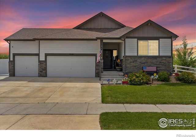 1520 Lake Vista Way, Severance, CO 80550 - view of front of house with an attached garage, concrete driveway, stone siding, and board and batten siding