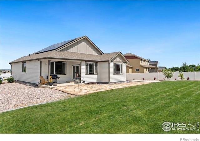 1520 Lake Vista Way, Severance, CO 80550 - back of house with roof mounted solar panels, board and batten siding, and a patio area