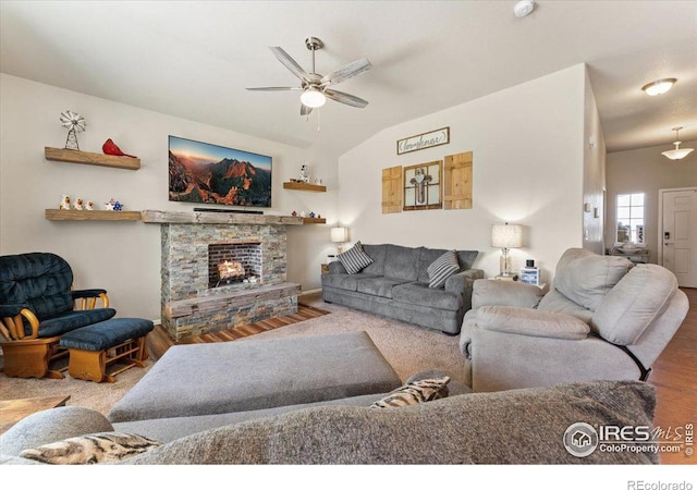 1520 Lake Vista Way, Severance, CO 80550 - living room with ceiling fan, a stone fireplace, wood finished floors, and vaulted ceiling