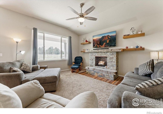 1520 Lake Vista Way, Severance, CO 80550 - living area featuring a ceiling fan, lofted ceiling, wood finished floors, and a stone fireplace