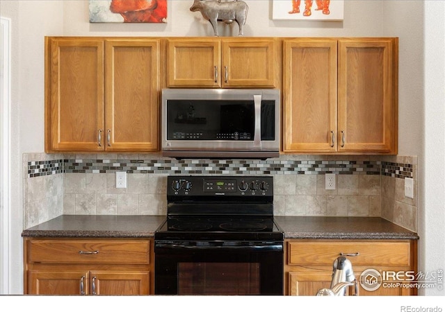 1520 Lake Vista Way, Severance, CO 80550 - kitchen with stainless steel microwave, black electric range oven, dark countertops, and tasteful backsplash