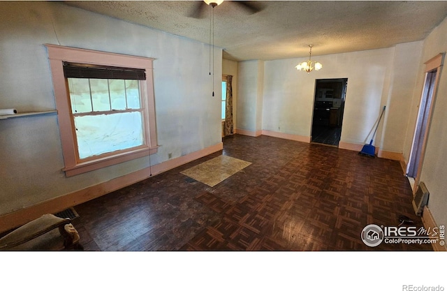 710 Carson St, Brush, CO 80723 - empty room featuring a chandelier, a textured ceiling, and a ceiling fan