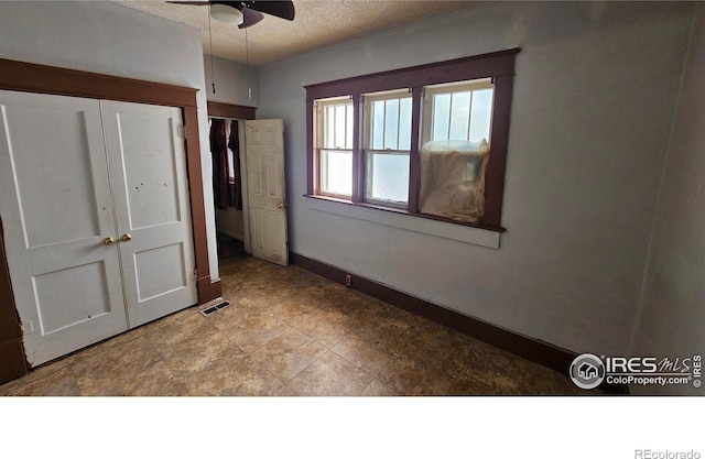 710 Carson St, Brush, CO 80723 - unfurnished bedroom featuring a textured ceiling and ceiling fan