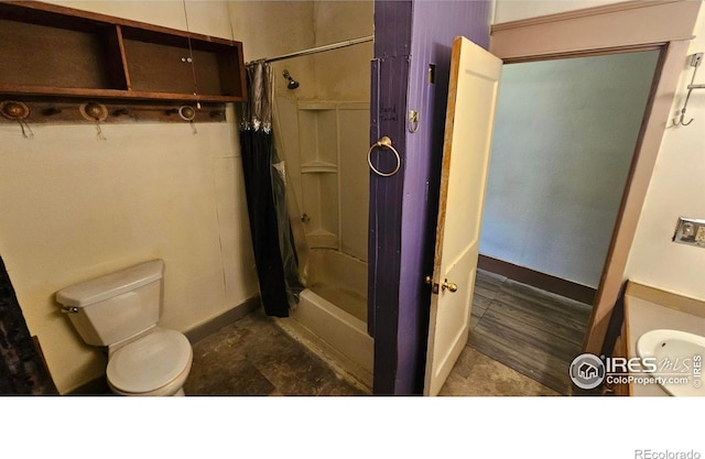 710 Carson St, Brush, CO 80723 - full bathroom featuring toilet and a shower with shower curtain