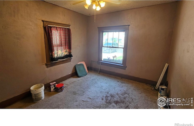 710 Carson St, Brush, CO 80723 - unfurnished room featuring carpet, a ceiling fan, and a textured wall