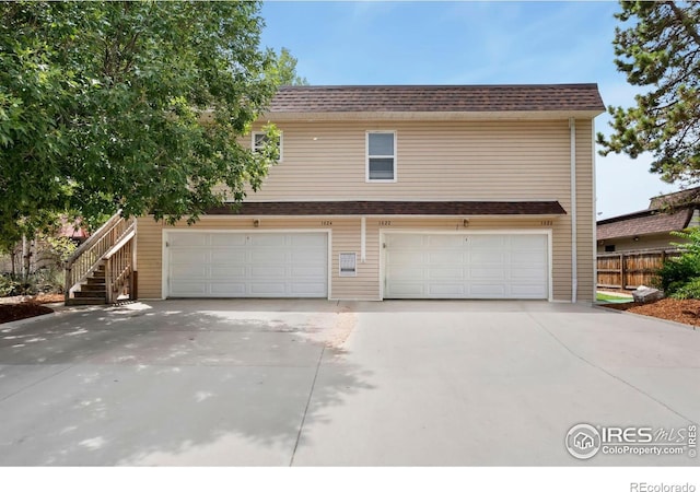 1620-1626 E 17th St, Loveland, CO 80538 - view of front facade featuring an attached garage, concrete driveway, and stairway