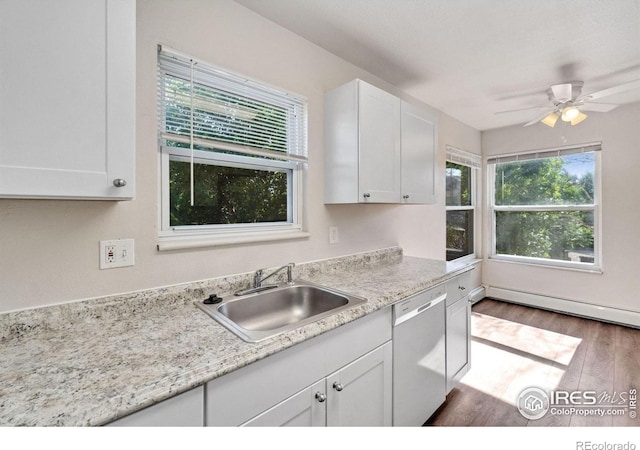 1620-1626 E 17th St, Loveland, CO 80538 - kitchen with stainless steel dishwasher, wood finished floors, white cabinetry, baseboard heating, and ceiling fan