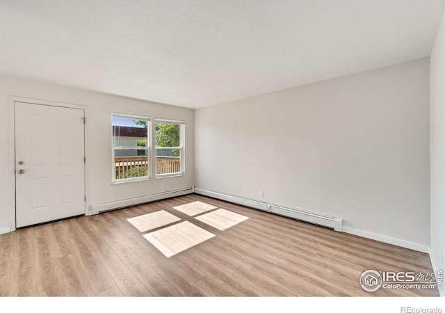 1620-1626 E 17th St, Loveland, CO 80538 - empty room featuring baseboard heating, a baseboard radiator, and wood finished floors