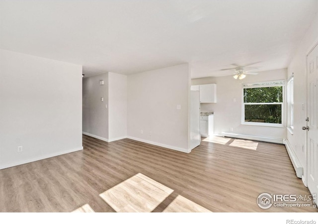 1620-1626 E 17th St, Loveland, CO 80538 - unfurnished living room with ceiling fan, light wood-style floors, and a baseboard radiator