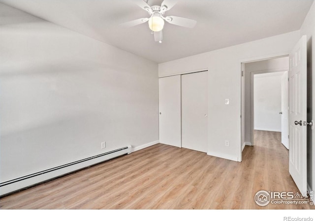 1620-1626 E 17th St, Loveland, CO 80538 - unfurnished bedroom with a baseboard radiator, light wood-style floors, a closet, and ceiling fan